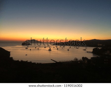 Boats in a Bay at Sunset