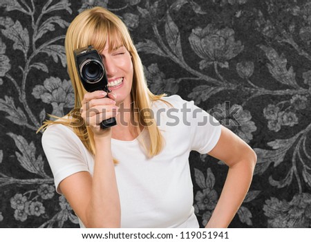 Happy Woman Looking Through Camera against a vintage floral background