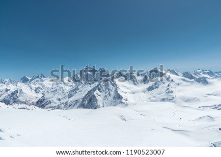 Winter snow covered mountain peaks in Caucasus. Great place for winter sports Royalty-Free Stock Photo #1190523007