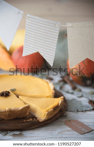pumpkin pie and a light wooden background. pumpkins, autumn leaves and spices. Thanksgiving Day