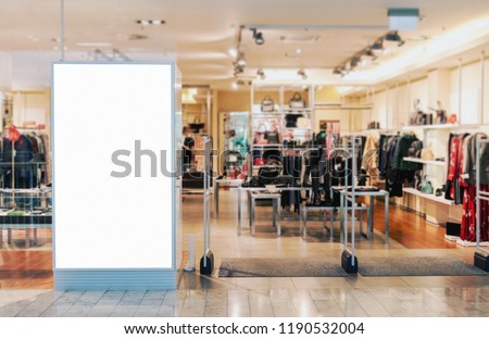 Clothes shop entrance with empty billboard mockup to place text, logo or advertisement 