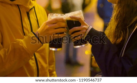 Close up shot of two friends drinking beer