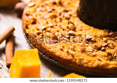 Pumpkin pancakes on a wooden background. Autumn food