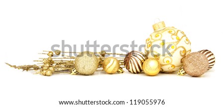 Group of gold Christmas baubles and branches arranged as a border over white