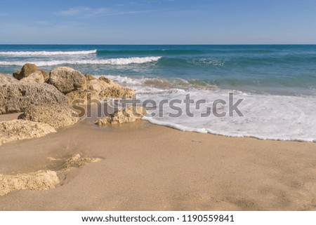 Beautiful warm sand, large course rocks provides a balance between the ocean and sky.