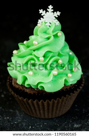 Christmas tree cupcake with green cream frosting, beautiful chocolate cake shaped fairy Christmas tree
