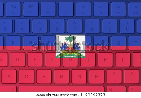 Haiti flag and computer keyboard in the background