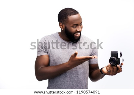 Look at this! An African American man on a white background, he made a purchase for his collection of rarity equipment and he is happy to photograph it on tape is his favorite thing