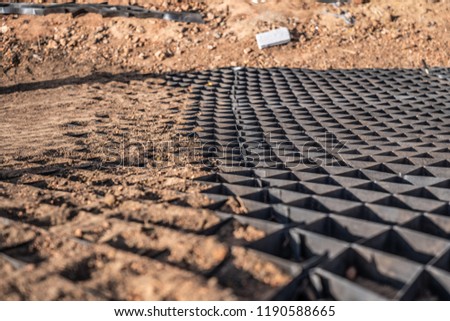 black geogrid filled with soil for stability of steep hill Royalty-Free Stock Photo #1190588665