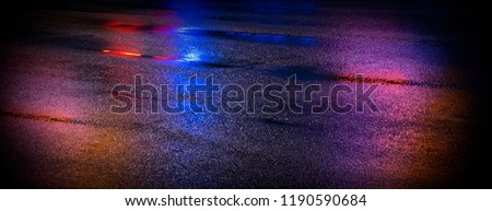 Background of wet asphalt with neon light. Blurred background, night lights, reflection. Royalty-Free Stock Photo #1190590684