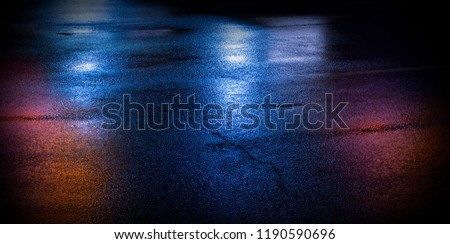 Background of wet asphalt with neon light. Blurred background, night lights, reflection. Royalty-Free Stock Photo #1190590696