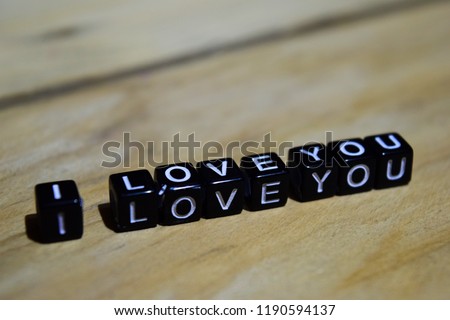 I love you written on wooden blocks. Inspiration and motivation concepts. Cross processed image on Wooden Background