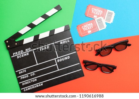 Movie time, flat lay. Cinema minimal concept. Composition on a red-green-blue background with a movie, 3D glasses and movie tickets