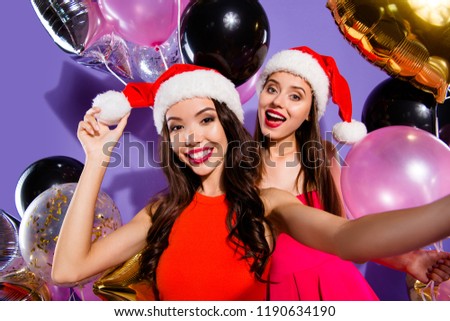 Two friendship ladies make selfie picture on modern smartphone gadget isolated on bright violet background with luxury helium blow decoration