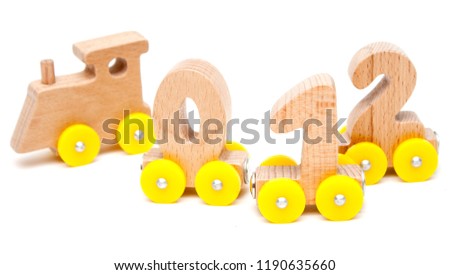 wooden numbers 0, 1, 2, 3,4,5 letters train cars alphabet with yellow wheels on white background. Early childhood education, learning to count, preschool and kids game concept.