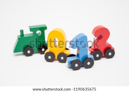 wooden numbers 0,1,2 letters train alphabet . Bright colors of red yellow green on a white background. Early childhood education, learning to count, preschool and kids game concept.