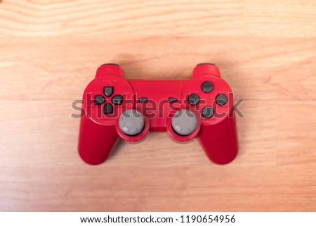 Red Console on wooden background