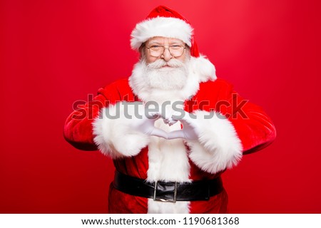 Festive noel seasonal kind positive stylish aged Santa look at camera make nice smile and shape heart with fingers hands isolated on bright red background