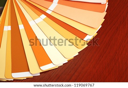 open RAL pantone sample colors catalogue on wood background, horizontal image