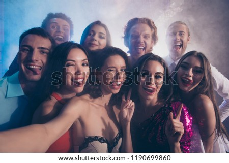 Best party mood! Close up photo portrait of couple of friends make picture, selfie on front camera of smartphone show tongue, stick out and wink eye