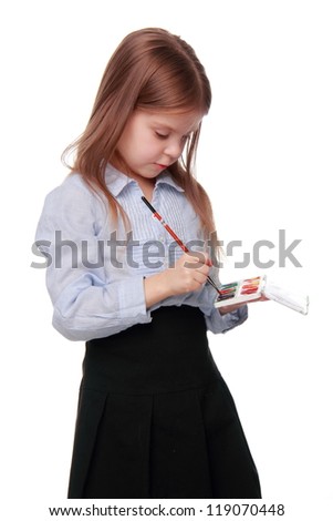 Lovely little schoolgirl with paint over white background on Education theme/Pretty little girl is painting