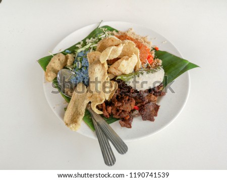 Delicious blue color rice salad or  "Nasi Kerabu"  known in malay is a traditional Malaysians cuisines