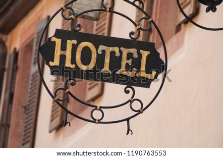 closeup of vintage hotel signage on metallic panel 