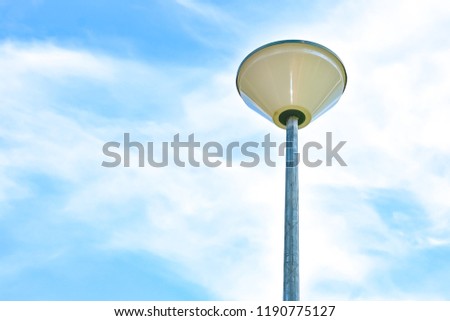 The lamp on the pole has the sky as the background.