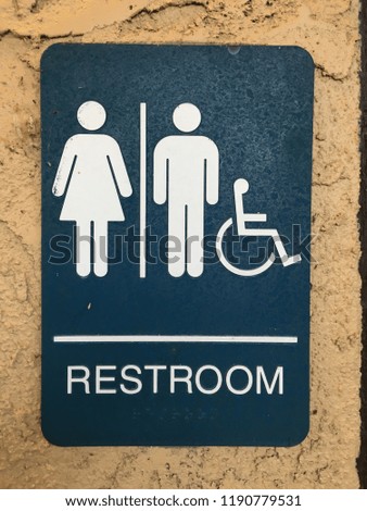 Restroom sign with woman, man, wheelchair