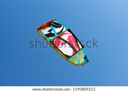 Kiteboarding kite. Colorful kite flying in blue sky.