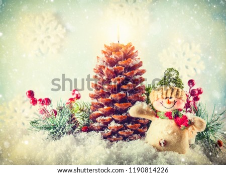 Snowman and Christmas candle in shape pinecone in the snow. Vintage style