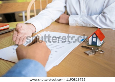 estate agent with customer after contract signature of buying house