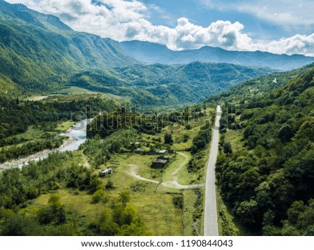 Areal view of mountains, cliffs, river and 
 road