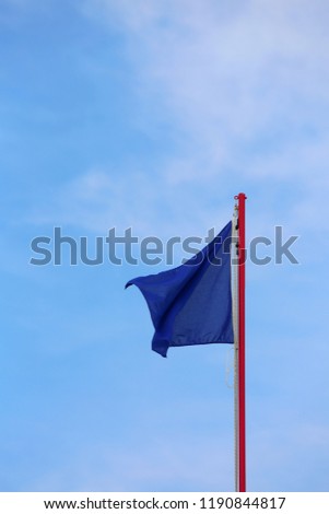 blue flag waves on the sky. This is the symbol of without pollution in this area