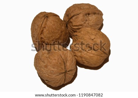 view of four walnuts on white background