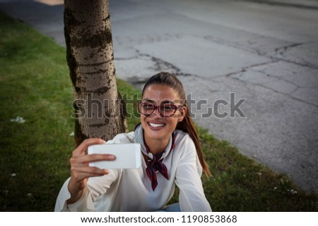 Pretty woman using phone,selfie.