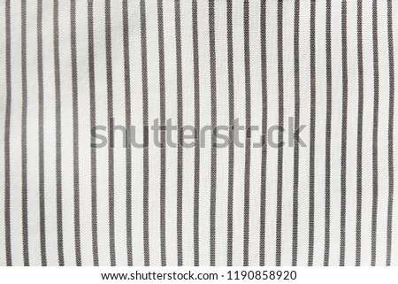 light linen fabric in a fine and wide black strip used for tablecloths, drapes. light coarse coarse linen cloth in a wide black strip used for tablecloths, bedspreads and carpets
