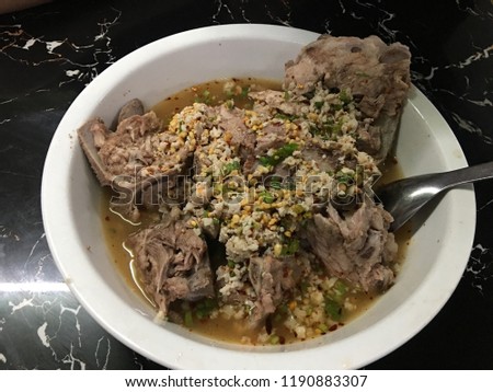 Pork ribs and bones in spicy Thai Tom Yum Soup - Thai food