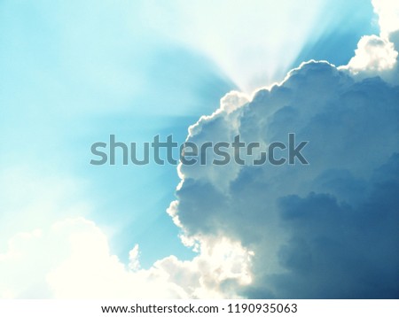 Cloudy blue sky background with sun ray.