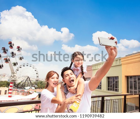 happy family taking selfie in the park