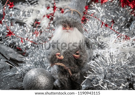 New Year's and Christmas with a Santa doll on the background of decor and ornaments