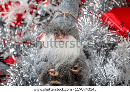 New Year's and Christmas  with a Santa doll on the background of decor and ornaments