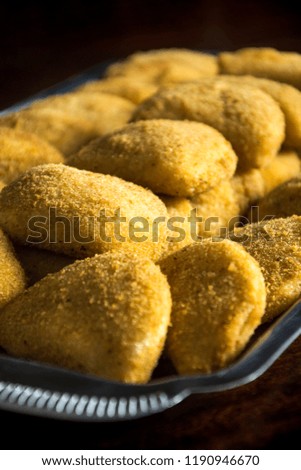 Risoles on silver platter. Is a snack, a type of crayon in a crescent shape made of pre-cooked pasta of wheat flour.
