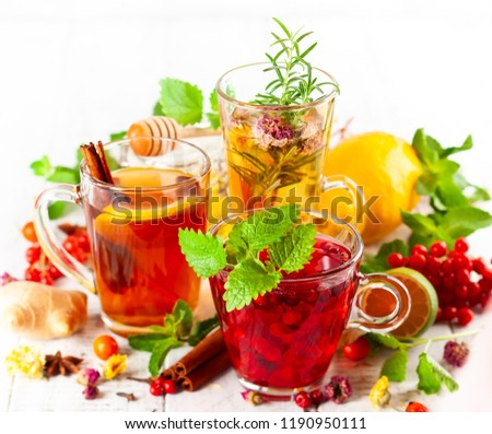 Assorted of healthy medical drinks  for autumn-winter season. Herbal tea with berries, spices, dried flowers and citrus.