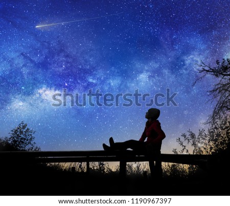 Girl watching the stars in night sky