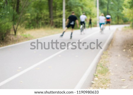 People rollerblading and Biking. Out of focus