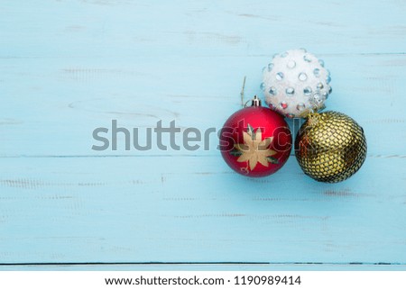 Top view of three beautiful Christmas balls on the wooden table