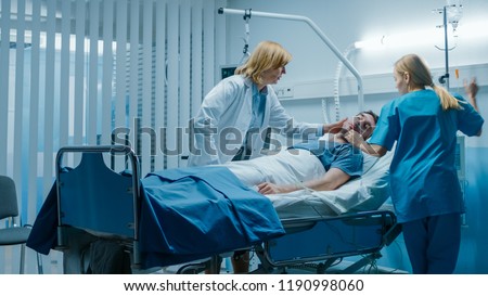 Emergency in the Hospital, Doctor and Nurse Rush to Safe Dying Patient. Man is Lying on the Bed without Signs of Life. Doctors Do Everything to Resuscitate Him. Royalty-Free Stock Photo #1190998060
