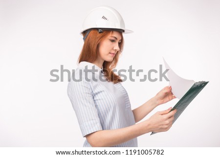 Architect, worker and realtor concept - woman builder or engineer with documents on white background with copy space