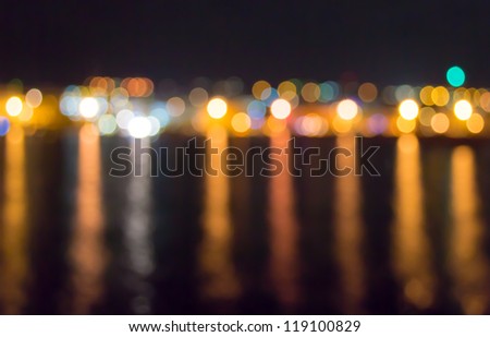 Abstract celebratory background of defocused lights with reflection